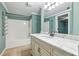 Bathroom featuring a white vanity with a stone countertop and tub/shower combo at 3115 Chimney Cove Ln, Cumming, GA 30041