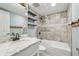 Bathroom with marble top vanity, custom shelving and tiled shower at 3115 Chimney Cove Ln, Cumming, GA 30041