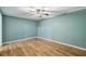 Bright room features unique wood-look paneled walls, hardwood floors and a ceiling fan at 3115 Chimney Cove Ln, Cumming, GA 30041
