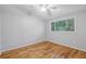 A bright bedroom with light gray walls, natural light, hardwood floors and a ceiling fan at 3115 Chimney Cove Ln, Cumming, GA 30041