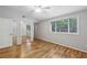 Bedroom with hardwood floors, closet with mirrored doors, and a large window at 3115 Chimney Cove Ln, Cumming, GA 30041