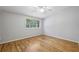 Bright bedroom featuring hardwood floors, neutral paint and a large window at 3115 Chimney Cove Ln, Cumming, GA 30041