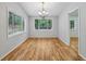 Traditional dining room with hardwood floors, grey walls and large window at 3115 Chimney Cove Ln, Cumming, GA 30041
