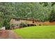 Charming home with a blend of stone and siding, a well-maintained lawn, and a inviting front porch at 3115 Chimney Cove Ln, Cumming, GA 30041