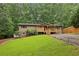 Charming home with a blend of stone and siding, a well-maintained lawn, and a inviting front porch at 3115 Chimney Cove Ln, Cumming, GA 30041