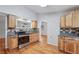 Well-lit kitchen featuring wood cabinets, granite countertops, and stainless steel appliances for a modern and functional space at 3115 Chimney Cove Ln, Cumming, GA 30041
