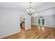 View of the living room with hardwood floors, a doorway to the kitchen, and french doors to the deck at 3115 Chimney Cove Ln, Cumming, GA 30041