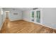Spacious living room featuring a pair of French doors and hardwood flooring at 3115 Chimney Cove Ln, Cumming, GA 30041