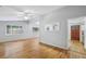 Open living room with hardwood floors and bright windows, featuring a seamless flow into the kitchen at 3115 Chimney Cove Ln, Cumming, GA 30041
