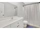 Clean bathroom with a vanity, toilet, and bathtub with shower curtain at 4055 Hill Station Ct, Sugar Hill, GA 30518