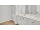 Bright bathroom featuring a double sink vanity, white cabinets, and a toilet, providing a clean and functional space at 4055 Hill Station Ct, Sugar Hill, GA 30518