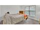 Relaxing bedroom with a comfortable bed, dresser, and large window letting in natural light at 4055 Hill Station Ct, Sugar Hill, GA 30518