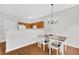 Bright dining area features an elegant chandelier, hardwood floors, and seating for four near the kitchen at 4055 Hill Station Ct, Sugar Hill, GA 30518