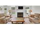 Inviting living room features a fireplace, plush seating, and natural light from the bright windows at 4055 Hill Station Ct, Sugar Hill, GA 30518