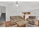 Spacious living room with comfortable seating, fireplace, and stairs to the upper level of the home at 4055 Hill Station Ct, Sugar Hill, GA 30518