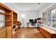 Bright home office featuring hardwood floors, built-in shelves, and natural light at 4055 Hill Station Ct, Sugar Hill, GA 30518