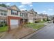 Street view of townhomes showing tidy lawns and community ambiance at 4055 Hill Station Ct, Sugar Hill, GA 30518