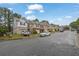 Street view of townhomes showcasing the neighborhood's well-maintained exteriors and community feel at 4055 Hill Station Ct, Sugar Hill, GA 30518