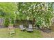 A private backyard seating area offers a tranquil escape surrounded by nature at 425 Starfire Ct, Suwanee, GA 30024
