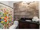 Bathroom with decorative shower curtain, wood-look tile wall, and granite vanity top at 425 Starfire Ct, Suwanee, GA 30024