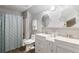 Bathroom featuring double sinks, patterned shower curtain, and tiled floors at 425 Starfire Ct, Suwanee, GA 30024