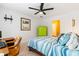 Cozy bedroom with ceiling fan, lime-green cabinet, and view into the en-suite bathroom at 425 Starfire Ct, Suwanee, GA 30024