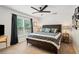Comfortable bedroom features a ceiling fan, window, and a dark wood frame bed set with bedside tables at 425 Starfire Ct, Suwanee, GA 30024