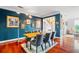 Stylish dining room with blue walls, hardwood floors, and ample space for seating and entertaining at 425 Starfire Ct, Suwanee, GA 30024