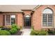 Close-up of the home's entrance, showcasing the brick facade, windows, and landscaped garden at 425 Starfire Ct, Suwanee, GA 30024