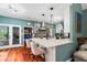 Open-concept kitchen featuring bar seating, stylish light fixtures, and a chef's kitchen at 425 Starfire Ct, Suwanee, GA 30024