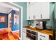 Gourmet coffee and beverage station with built-in cabinet and dark wood countertop at 425 Starfire Ct, Suwanee, GA 30024