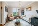 Cozy living room with designer wallpaper, a comfortable seating arrangement, and stylish accents at 425 Starfire Ct, Suwanee, GA 30024