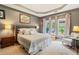 Serene main bedroom featuring tray ceilings and a sitting area with plenty of natural light at 425 Starfire Ct, Suwanee, GA 30024