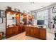 Office featuring a decorative display cabinet with glass shelving, and a large wooden executive desk at 425 Starfire Ct, Suwanee, GA 30024