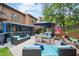 Outdoor living space with comfortable seating, a dining area, and a spa for relaxation and entertaining at 425 Starfire Ct, Suwanee, GA 30024