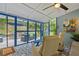 Enclosed patio features modern patterned flooring and views of the backyard and an outdoor seating area at 425 Starfire Ct, Suwanee, GA 30024