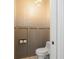 Stylish powder room with patterned wallpaper, modern fixtures, and wainscoting at 425 Starfire Ct, Suwanee, GA 30024