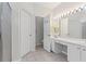 Bright bathroom with double vanity, a large mirror with Hollywood lights and tiled flooring at 6360 Waveland Dr, Cumming, GA 30040