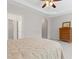 A spacious bedroom with a bed, carpeted floors, and a wooden dresser at 6360 Waveland Dr, Cumming, GA 30040