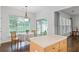 Bright breakfast nook features a round table, wooded chairs, and hardwood flooring at 6360 Waveland Dr, Cumming, GA 30040