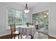 Bright breakfast nook features a round table, wooded chairs, and hardwood flooring at 6360 Waveland Dr, Cumming, GA 30040