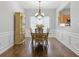 Elegant dining room with hardwood floors, wainscoting, and a chandelier at 6360 Waveland Dr, Cumming, GA 30040