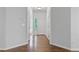 Entryway featuring dark wood floors, white trim, and a view of the front door at 6360 Waveland Dr, Cumming, GA 30040