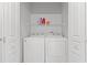 Laundry closet equipped with a washer, dryer, and upper shelf for storage at 6360 Waveland Dr, Cumming, GA 30040