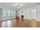 Spacious living room with hardwood floors, fireplace, and large windows for natural light at 6360 Waveland Dr, Cumming, GA 30040