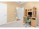 Office space featuring a wood desk, built-in shelves, and neutral carpeting at 6360 Waveland Dr, Cumming, GA 30040
