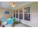 A screened porch with a table and chairs, a ceiling fan, and lots of natural light at 6360 Waveland Dr, Cumming, GA 30040