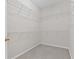 Walk-in closet featuring neutral carpeting and wire shelving for ample storage at 6360 Waveland Dr, Cumming, GA 30040