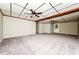Finished basement with two ceiling fans and a door to the exterior at 10 Canyon Cove Cv, Ellenwood, GA 30294