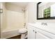 Standard bathroom with white vanity, mirror, toilet and tub/shower combo with window at 10 Canyon Cove Cv, Ellenwood, GA 30294